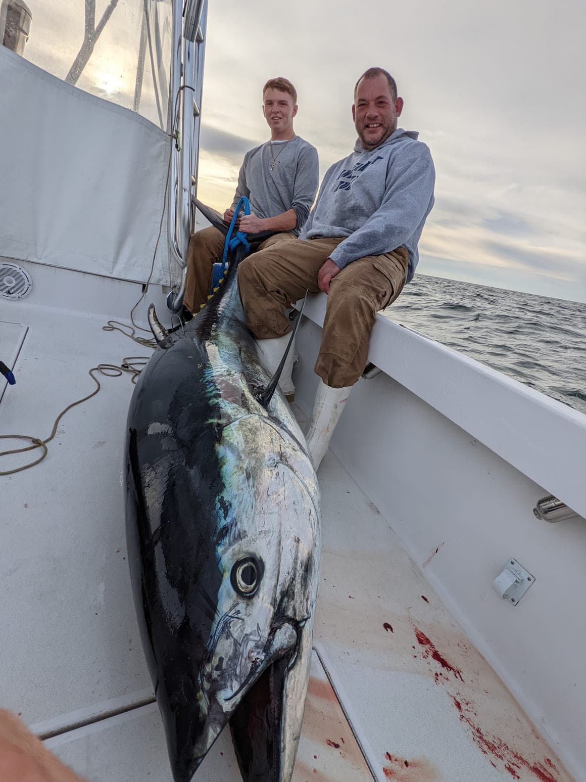 Two anglers on deck with a bluefin tuna