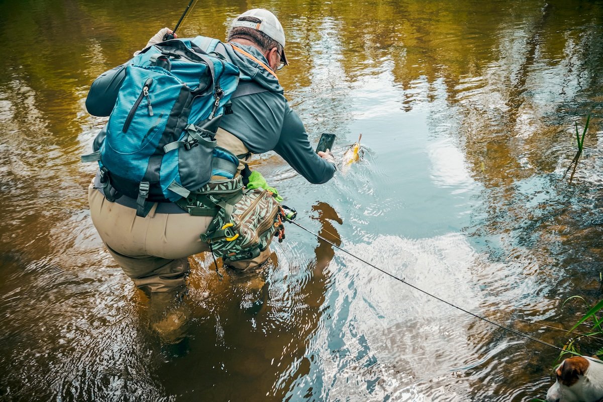 Fisherman taking pic of catch